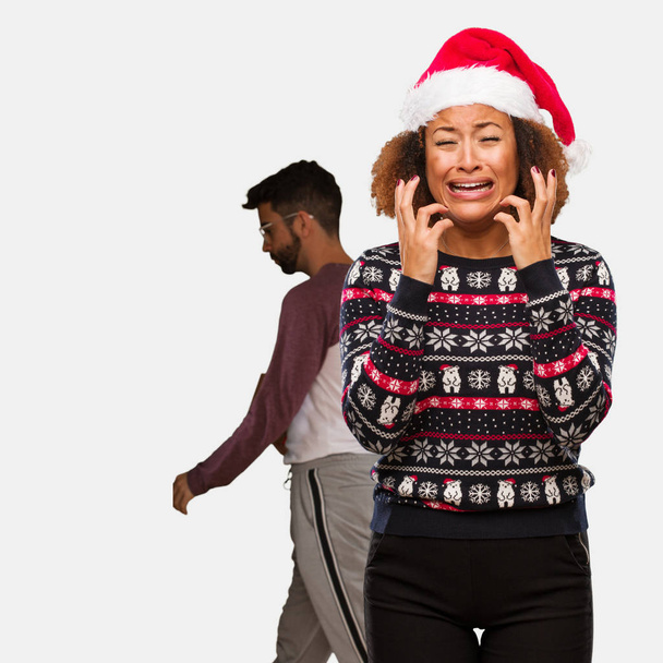 Young black woman in a trendy christmas sweater with print very scared and afraid - Photo, image