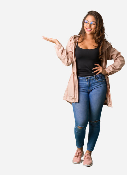 Full body young curvy woman holding something with hand - Photo, Image