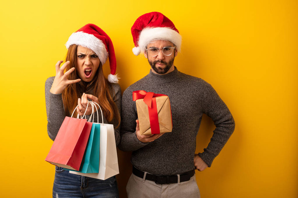 Couple or friends holding gifts and shopping bags angry and upset - Photo, Image