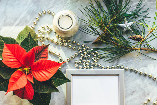 Christmas closeup mockup with poinsettia, pine wreath, notebook, with copy place. - Фото, изображение