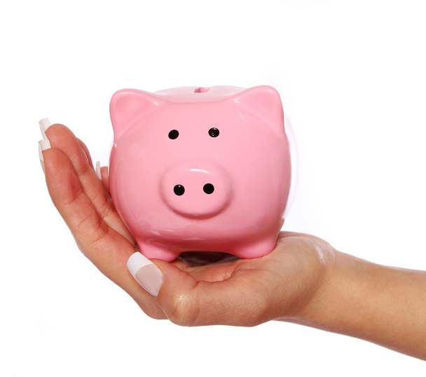 piggy bank in female hand isolated on white background - Фото, изображение