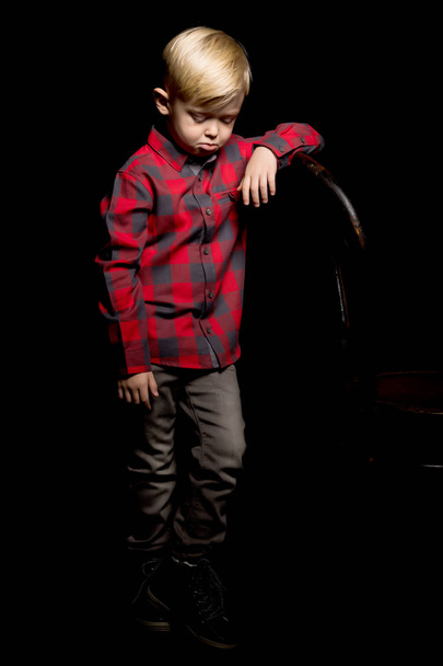 Little boy on a black background. - Fotó, kép