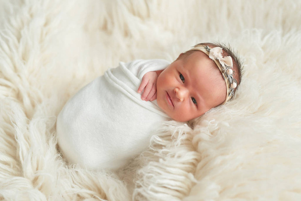 newborn girl on a white background in bed - Photo, Image