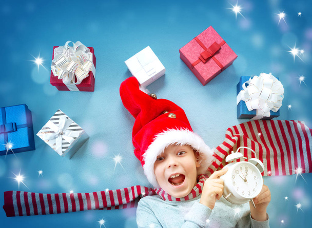 Smiling baby on red blanket with presents - 写真・画像