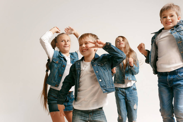 The portrait of cute little boy and girls in stylish jeans clothes looking at camera at studio - Φωτογραφία, εικόνα