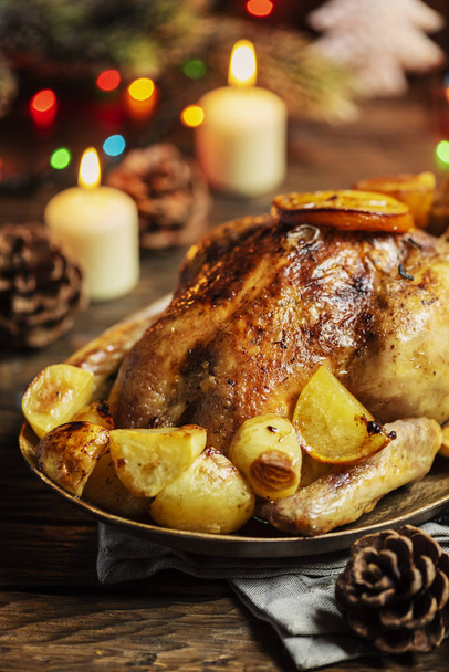 Roasted chicken with orange slices and potatoes for Christmas dinner - Фото, зображення