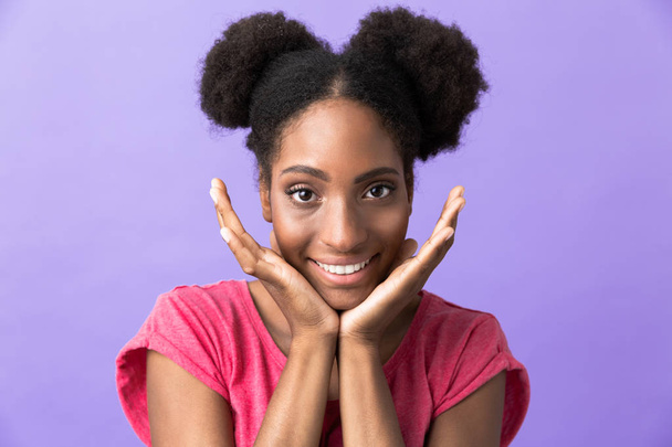 Photo of cheerful african american woman smiling and touching her face isolated over violet background - Valokuva, kuva