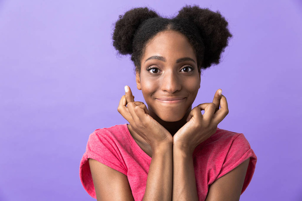 Photo of amusing african american woman smiling and touching her face isolated over violet background - Photo, Image