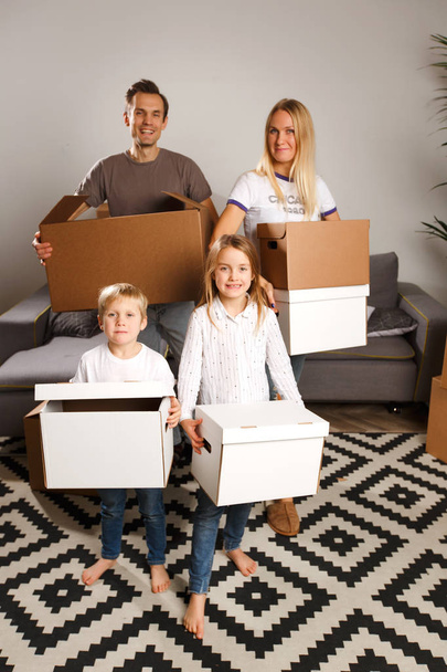Image of women, men and children holding cardboard boxes - Фото, изображение