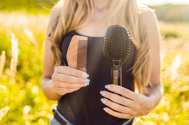 Zero waste concept. Use a wooden comb or plastic comb. Zero waste, green and conscious lifestyle concept. - Фото, изображение