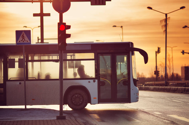 Bus moving on the road in city in early morning - Foto, Imagen