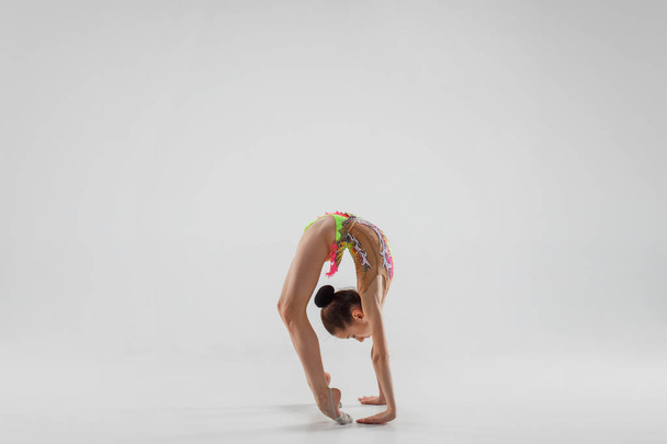 The teenager girl doing gymnastics exercises isolated on white background - Foto, Bild