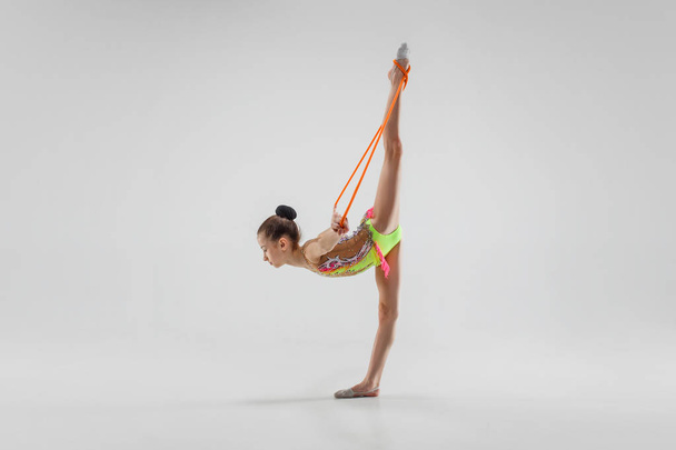 The teenager girl doing gymnastics exercises isolated on white background - Φωτογραφία, εικόνα