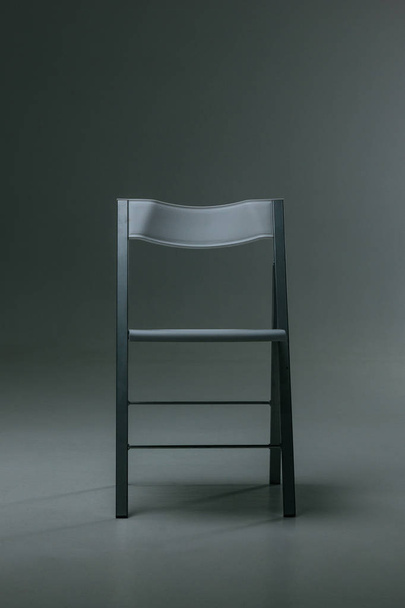 White plastic chair standing in empty room - Valokuva, kuva