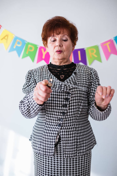 Senior woman celebrating her birthay at home - Фото, зображення