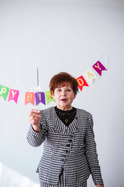 Senior woman celebrating her birthay at home - Photo, image