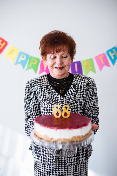 Senior woman celebrating her birthay at home - Photo, Image