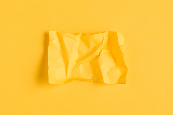 crumpled paper on yellow background with copy space - Zdjęcie, obraz