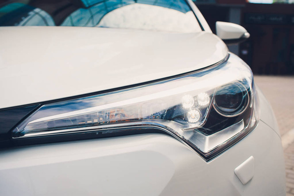 Led car headlight close-up. New modern vehicle detail light - 写真・画像