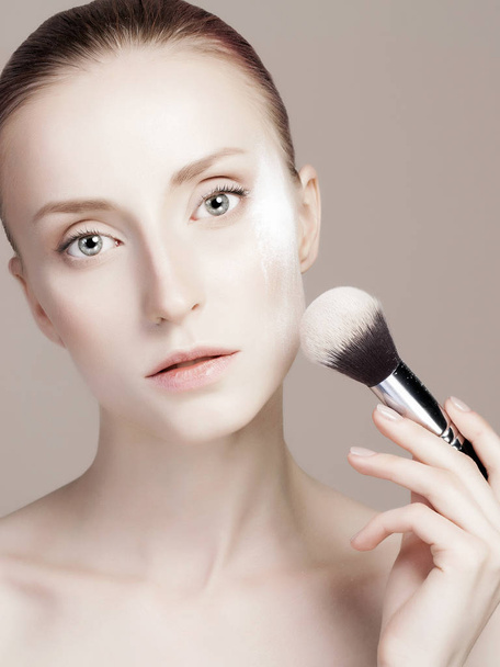 beautiful girl with make-up brush. Young woman Applying Make-up. clean skin, care, cosmetics - Foto, immagini