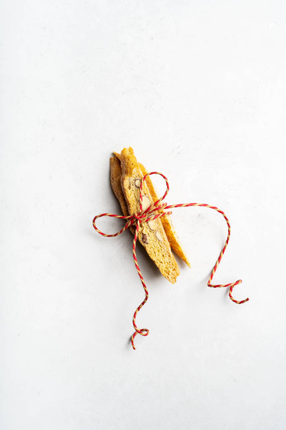 Traditional italian Biscotti tied with rope on a light stone surface  - Foto, Bild