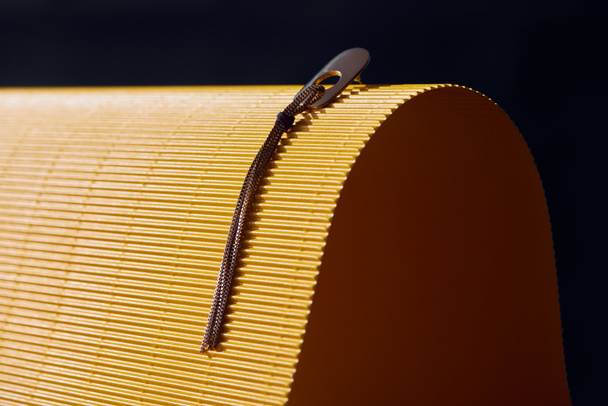 beautiful earring on yellow and black striped surface - Фото, зображення