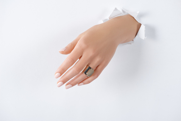 cropped image of woman holding hand with beautiful luxury ring through white paper - Fotografie, Obrázek
