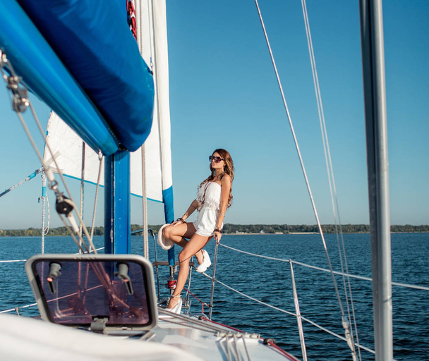 Young sexy woman in stylish clothes on private yacht  - Photo, Image