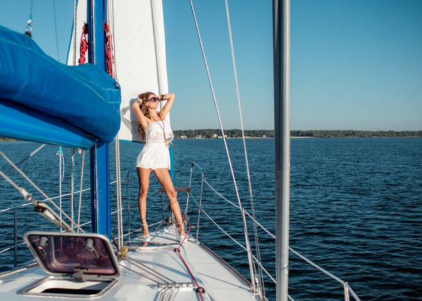 Young sexy woman in stylish clothes on private yacht  - Zdjęcie, obraz