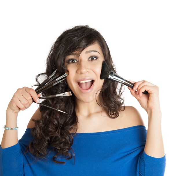 beautiful brunette holding a makeup brush - Фото, изображение
