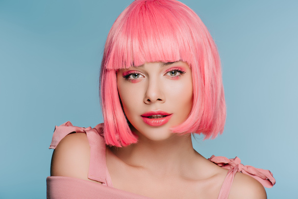 fashionable girl posing in pink wig isolated on blue - Photo, Image