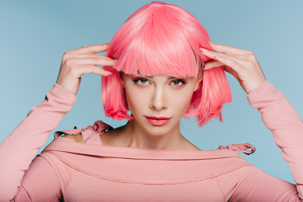 attractive stylish girl posing in pink wig isolated on blue - Фото, зображення