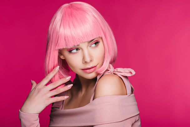 fashionable young woman gesturing and posing in pink wig, isolated on pink - Fotografie, Obrázek