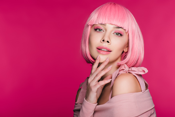 attractive stylish girl gesturing and posing in pink wig, isolated on pink - Valokuva, kuva
