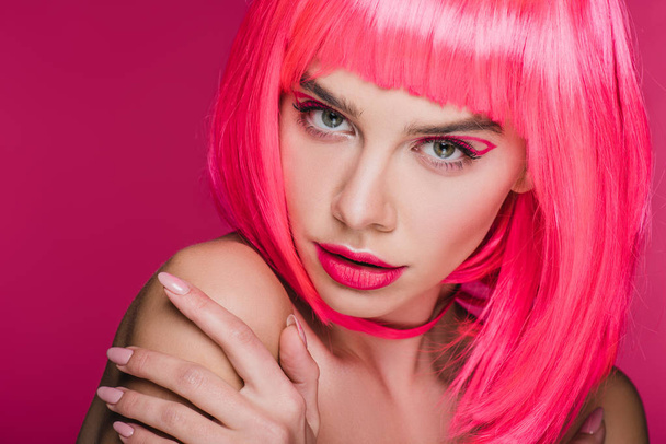 beautiful sensual girl posing in neon pink wig, isolated on pink - 写真・画像