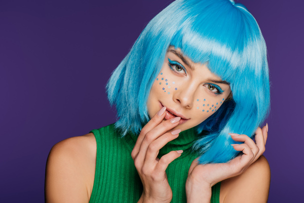 attractive fashionable girl with blue wig and stars on face, isolated on purple - Fotoğraf, Görsel