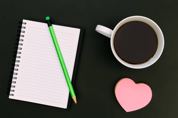 Notebook paper love heart coffee on dark background - Foto, afbeelding