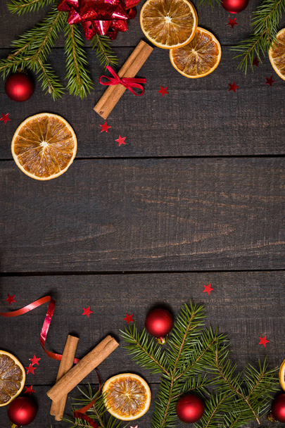 Dark rustic wood table flatlay - Christmas background with  decoration and fir branch  frame. Top view with free space for copy text - Foto, immagini