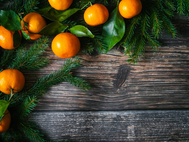 Christmas background with tangerines and fir branches. Winter holiday card for new year - Fotoğraf, Görsel