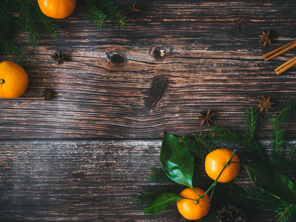 Christmas background with tangerines and fir branches. Winter holiday card for new year - 写真・画像
