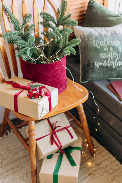 Rustic room decoration for Christmas parties with gift boxes and pine needles green brown beige - Фото, зображення