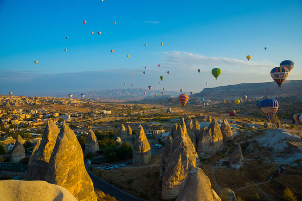 Cappadocia, Goreme, Anatolia, Turkey: The great tourist attraction of Cappadocia - balloon flight at sunrise. Cappadocia is place to fly with hot air balloons. - Photo, image