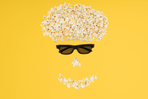 stereoscopic 3d glasses and fresh popcorn isolated on yellow - Photo, Image