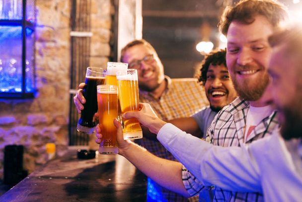young happy bearded men drinking with beer in pub and having fun - Foto, Imagen