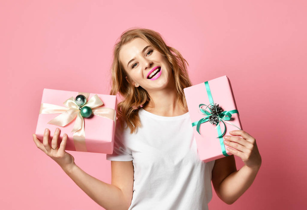 Beautiful woman composition hold pink and pastel green Christmas presents gifts for new year celebration - Photo, image