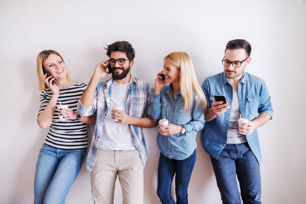 group of young happy coworkers having fun at break while drinking coffee - Photo, Image