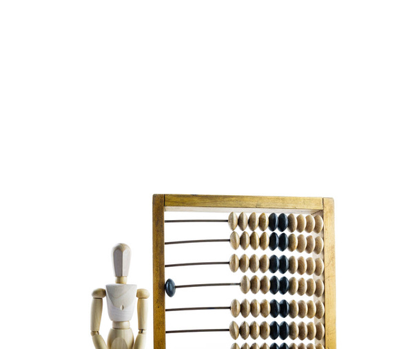 Wooden mannequin with wooden calculator on white background. Wooden abacus. - Foto, Bild