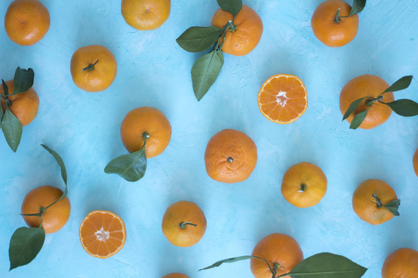 Tangerines on a blue background the top view. - 写真・画像