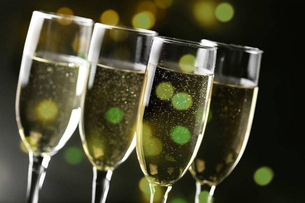 four glasses of champagne on  dark background, celebration concept - Fotoğraf, Görsel