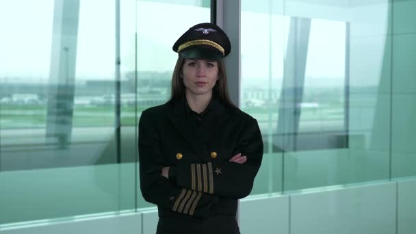 美しい女性パイロットが空港でポーズをとっている - 映像、動画
